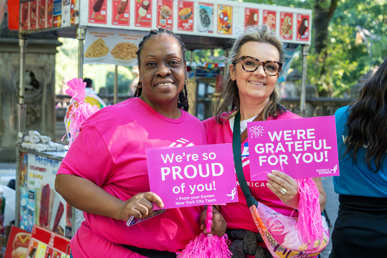 Two women at the NYC Race event holding signs' shoulders
