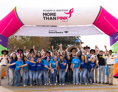 Austin Volunteers celebrating under the More than Pink Banner